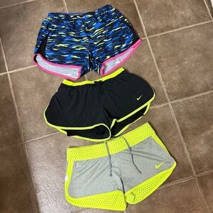 Nike Women's Athletic Shorts Lot - Blue, Black, Gray with Neon Accents.